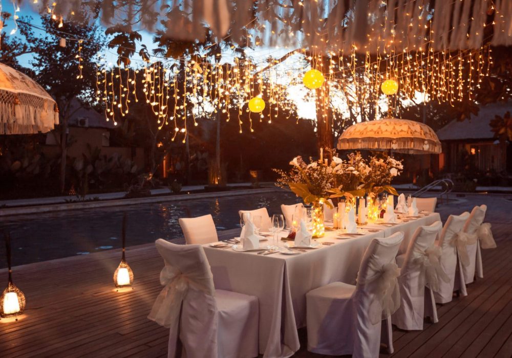 Wedding Banquet Or Gala Dinner Decorated With Garlands. Festive Wedding Banquet or gala dinner decorated with garlands. Festive table set up decor for wedding, party or event